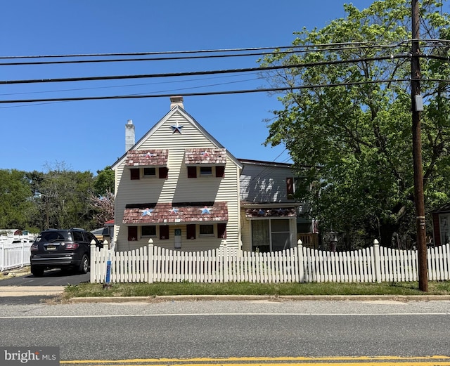 377 Main St, Cedarville, NJ 08311 - victorian-style house featuring a fenced front yard and a chimney