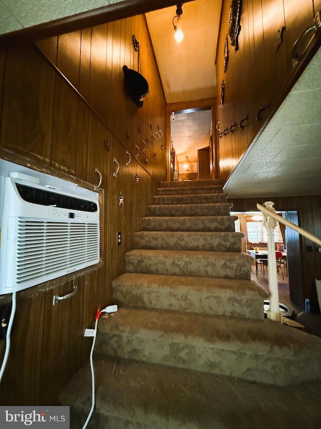 377 Main St, Cedarville, NJ 08311 - stairway with wooden walls, carpet, a wall unit AC, and lofted ceiling