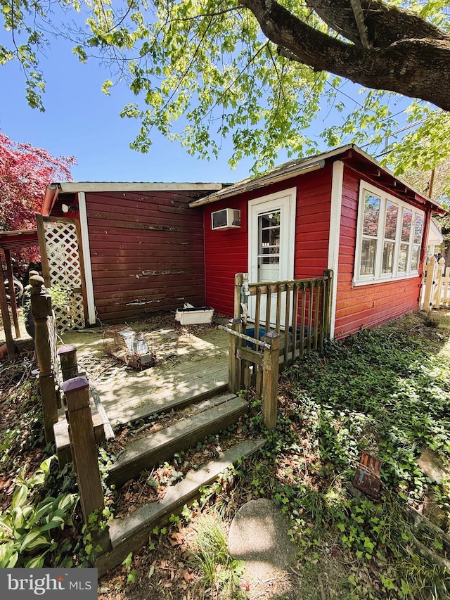 377 Main St, Cedarville, NJ 08311 - exterior space featuring an outdoor structure, a wall unit AC, and fence