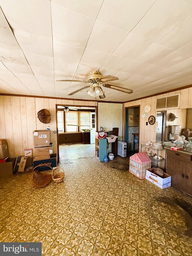 377 Main St, Cedarville, NJ 08311 - living room featuring ceiling fan, wood walls, and visible vents