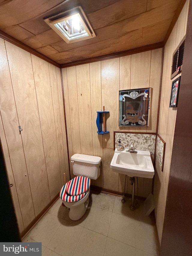 377 Main St, Cedarville, NJ 08311 - half bath with toilet, wooden walls, and tile patterned floors