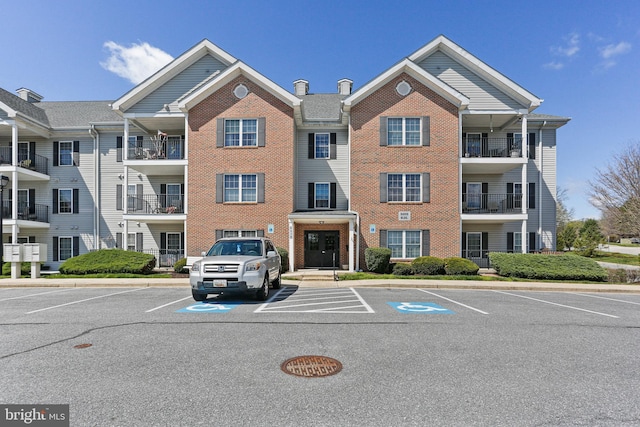 view of building exterior with uncovered parking
