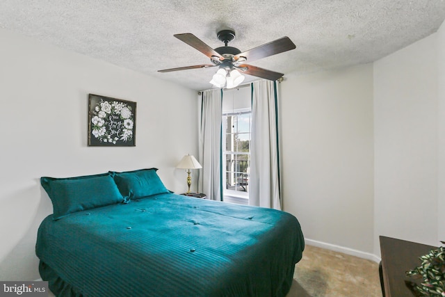 carpeted bedroom featuring baseboards, ceiling fan, and a textured ceiling