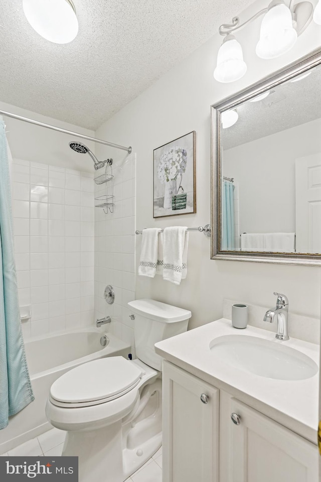 bathroom featuring tile patterned floors, a textured ceiling, vanity, and toilet