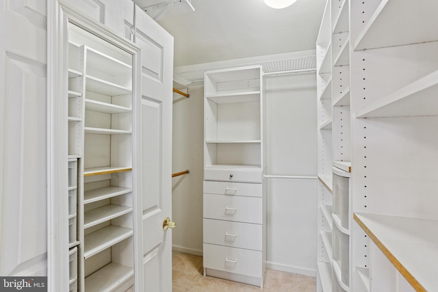 spacious closet with light tile patterned floors