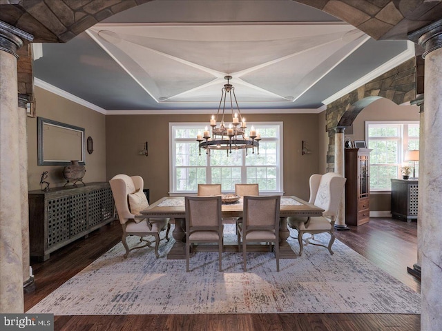 dining space with ornate columns, arched walkways, wood finished floors, and a chandelier