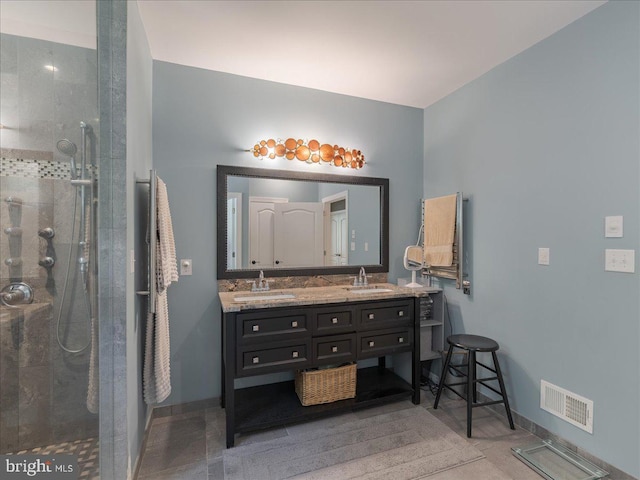 bathroom featuring visible vents, a sink, and baseboards