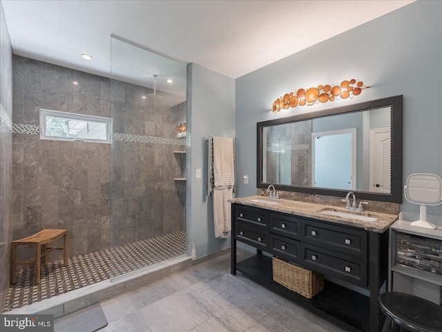 bathroom with double vanity, a sink, and a walk in shower