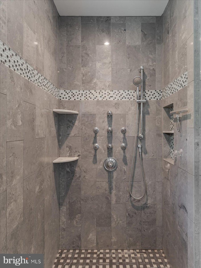bathroom with tiled shower