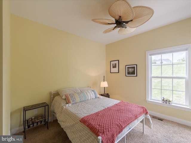 bedroom with visible vents, carpet flooring, baseboards, and a ceiling fan