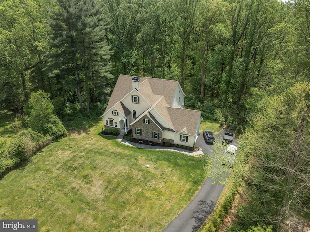 birds eye view of property with a forest view