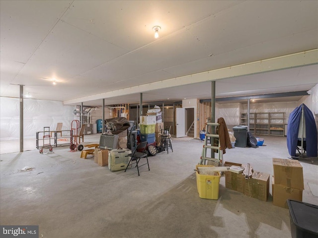 unfinished basement featuring stairs