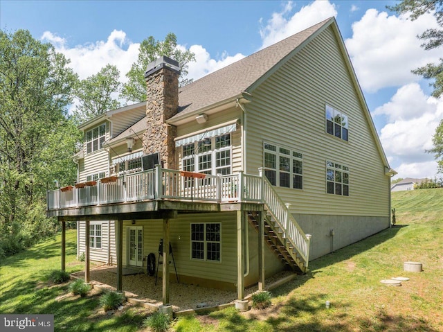 back of property with french doors, a chimney, a lawn, a wooden deck, and stairs
