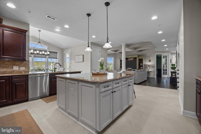 kitchen featuring stainless steel dishwasher, recessed lighting, vaulted ceiling, and a center island