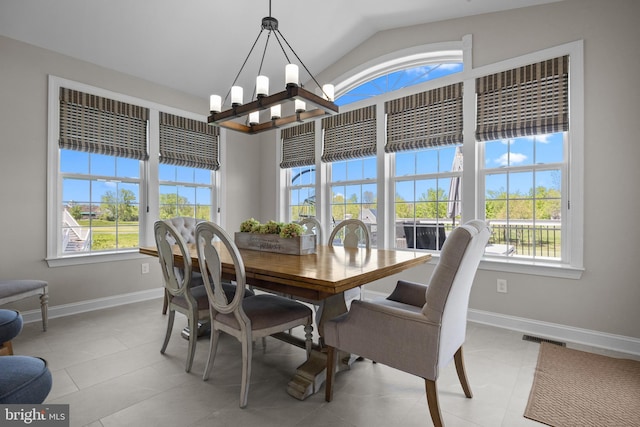 dining space featuring baseboards, visible vents, a healthy amount of sunlight, and an inviting chandelier