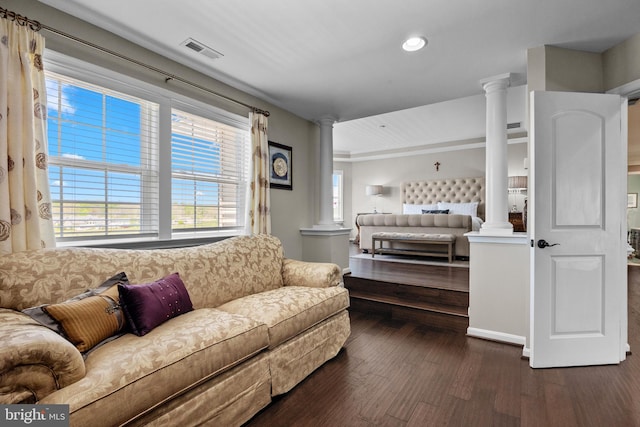living room with ornate columns, dark wood finished floors, recessed lighting, and visible vents