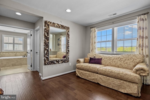 sitting room with visible vents, recessed lighting, and hardwood / wood-style flooring