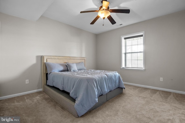 bedroom featuring carpet floors, baseboards, a ceiling fan, and visible vents