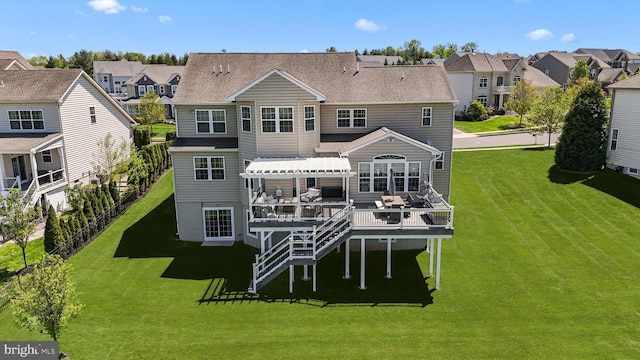 back of property featuring a residential view, a wooden deck, a lawn, and roof with shingles