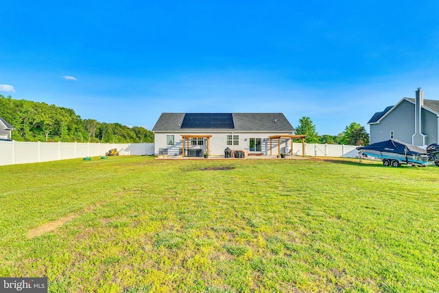 9937 Sodus Ct, Faulkner, MD 20632 - rear view of house featuring a fenced backyard, a patio area, solar panels, and a lawn