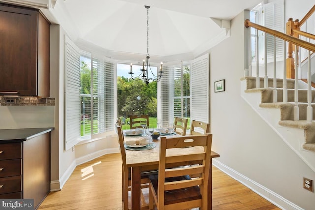 14309 Cervantes Ave, Darnestown, MD 20874 - dining space with light wood-style floors, baseboards, a notable chandelier, and stairway