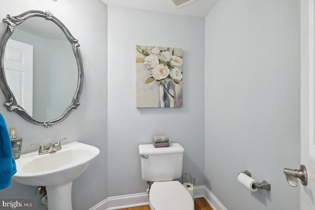 14309 Cervantes Ave, Darnestown, MD 20874 - bathroom featuring baseboards, a sink, wood finished floors, and toilet