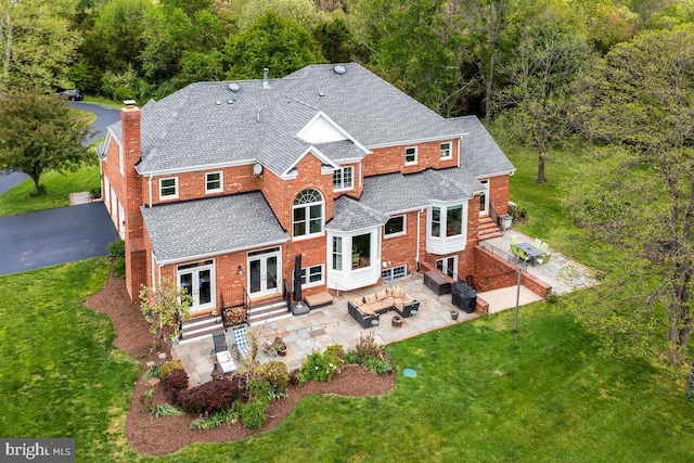 14309 Cervantes Ave, Darnestown, MD 20874 - rear view of house featuring an outdoor hangout area, entry steps, a chimney, french doors, and a lawn
