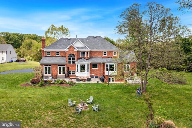 14309 Cervantes Ave, Darnestown, MD 20874 - back of house featuring french doors, a chimney, a patio area, brick siding, and an outdoor fire pit