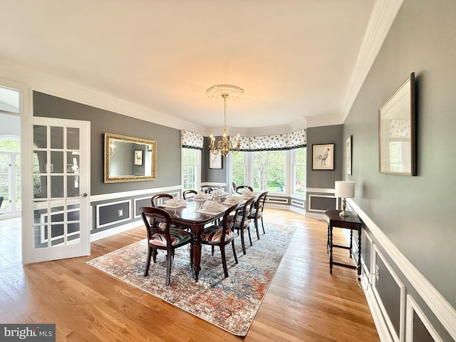 14309 Cervantes Ave, Darnestown, MD 20874 - dining area featuring a healthy amount of sunlight, ornamental molding, and an inviting chandelier