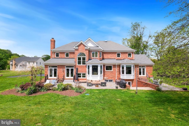 14309 Cervantes Ave, Darnestown, MD 20874 - rear view of house featuring french doors, a chimney, brick siding, a yard, and entry steps
