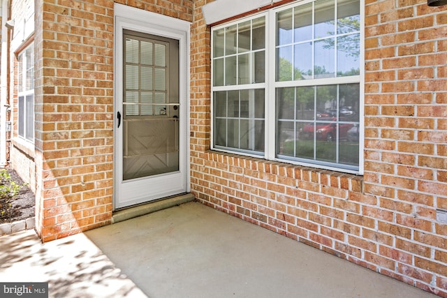 entrance to property with brick siding
