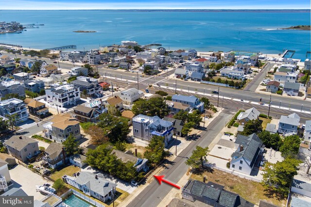 bird's eye view with a water view and a residential view