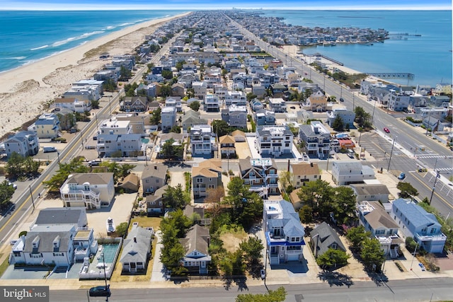 aerial view with a beach view, a water view, and a residential view