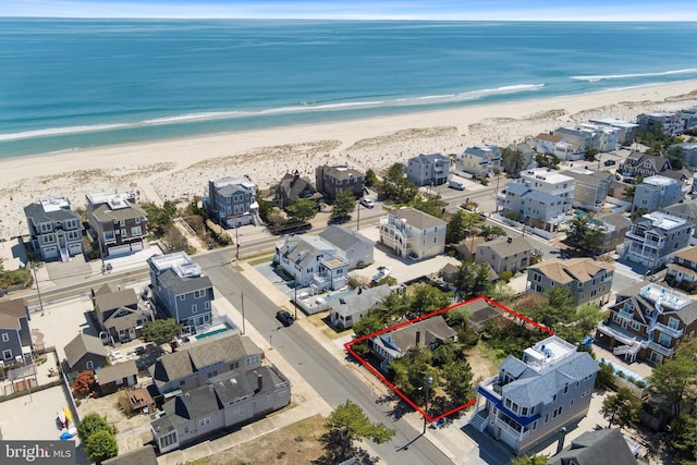 bird's eye view with a water view and a view of the beach