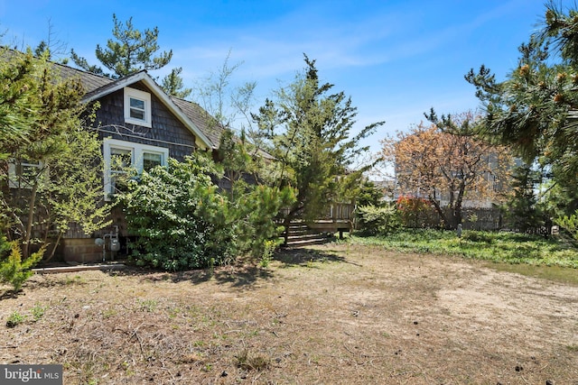 view of yard featuring a deck and fence