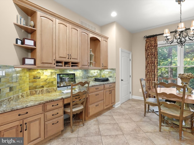 6 Jarretts Ct, Reisterstown, MD 21136 - kitchen featuring open shelves, built in desk, backsplash, light stone counters, and a chandelier