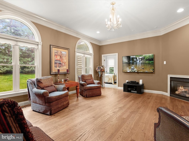 6 Jarretts Ct, Reisterstown, MD 21136 - living area with a chandelier, light wood-style flooring, crown molding, a glass covered fireplace, and recessed lighting