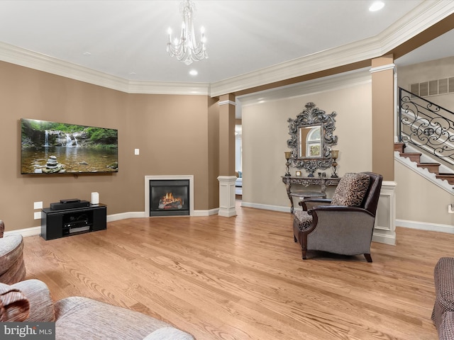 6 Jarretts Ct, Reisterstown, MD 21136 - living room with decorative columns, wood finished floors, a glass covered fireplace, stairway, and crown molding
