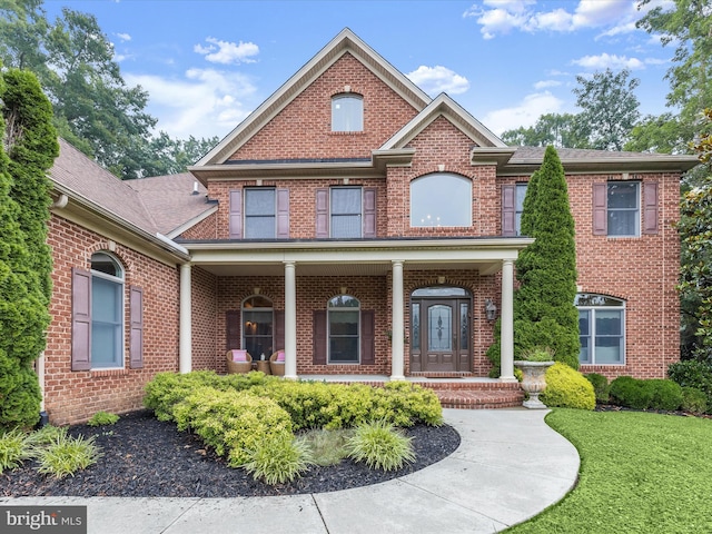 6 Jarretts Ct, Reisterstown, MD 21136 - view of front of property featuring brick siding, a porch, and a front lawn