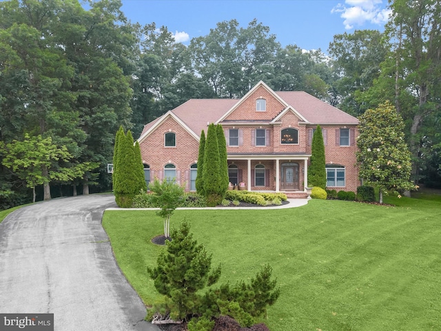 6 Jarretts Ct, Reisterstown, MD 21136 - colonial inspired home with a front lawn, a porch, and brick siding