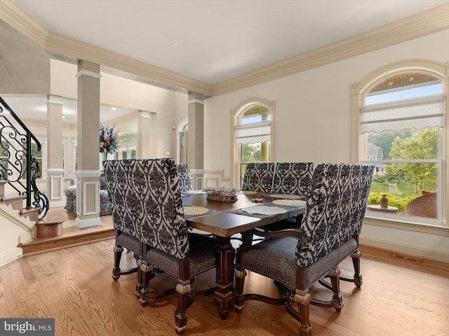 6 Jarretts Ct, Reisterstown, MD 21136 - dining room with ornate columns, ornamental molding, a decorative wall, light wood-type flooring, and a wainscoted wall