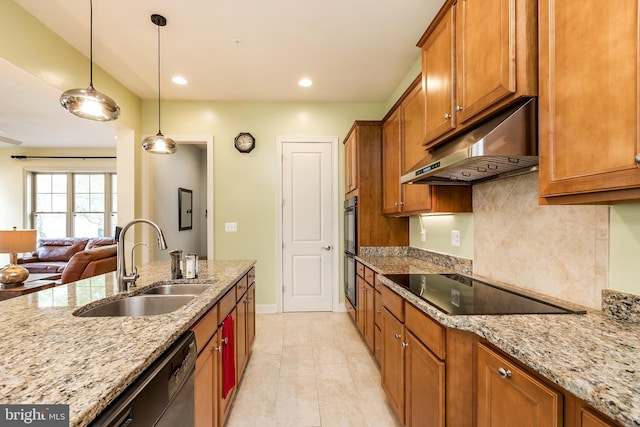kitchen featuring brown cabinets, a sink, black appliances, backsplash, and under cabinet range hood