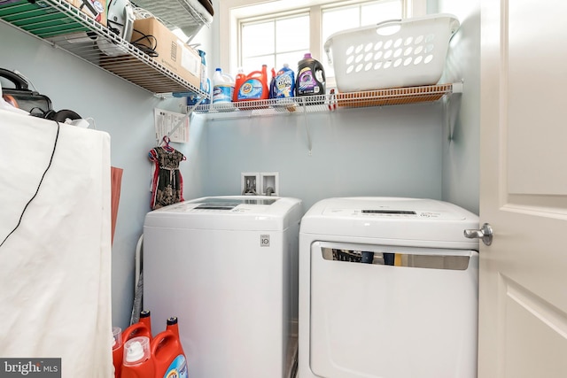 washroom featuring separate washer and dryer and laundry area
