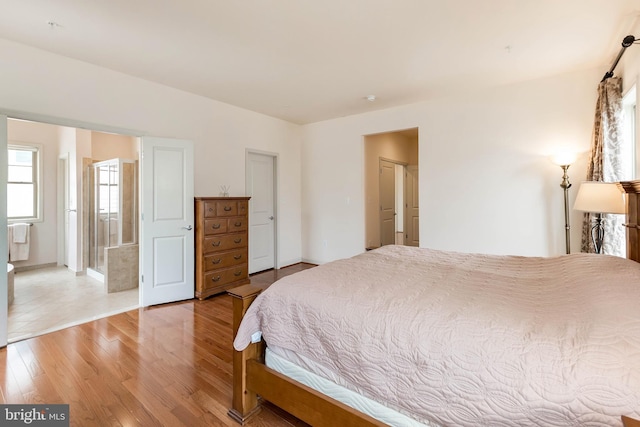 bedroom with light wood-style flooring and baseboards