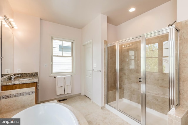 bathroom featuring a tub, vanity, visible vents, and a stall shower