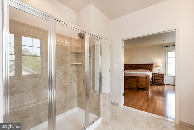full bath with connected bathroom, wood finished floors, and a stall shower
