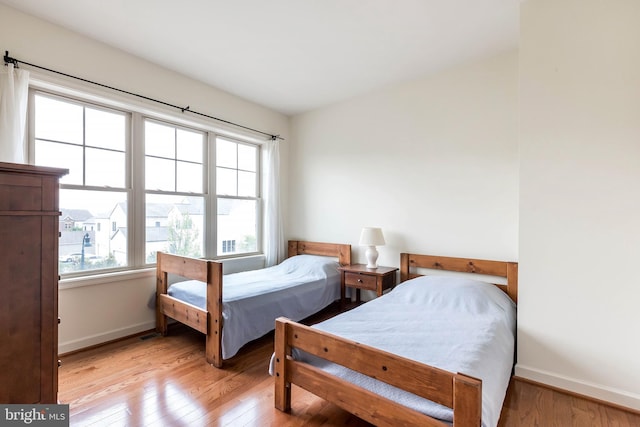 bedroom with baseboards and wood finished floors