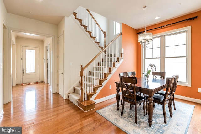 dining room with recessed lighting, baseboards, a chandelier, stairway, and light wood-type flooring
