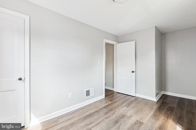 2026 S Oakland St S, Arlington, VA 22204 - unfurnished bedroom featuring visible vents, wood finished floors, and baseboards