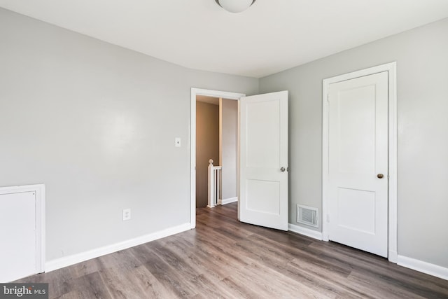 2026 S Oakland St S, Arlington, VA 22204 - unfurnished bedroom with visible vents, wood finished floors, and baseboards